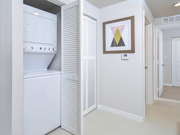 a white room with a bathroom and a closet at District West Gables, West Miami, FL